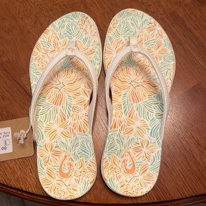 OluKai white flip flops